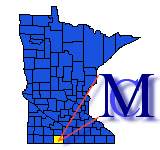 Logo for Martin County. Blue map of Minnesota, county lines showing.  To the right of the image a dark letter M is placed over a lighter blue colored letter C, and two lines from the edge of the letters point towards Martin County, which is highlighted in yellow on the map.with Martin County highlighted on the map.